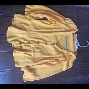 Yellow button up, sheer blouse.
